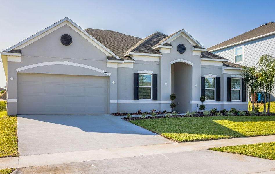 Front exterior of a new home in Malabar Springs, Palm Bay, FL, highlighting curb appeal (Image 26). Front exterior of a new home in Malabar Springs, Palm Bay, FL, highlighting curb appeal (Image 26).