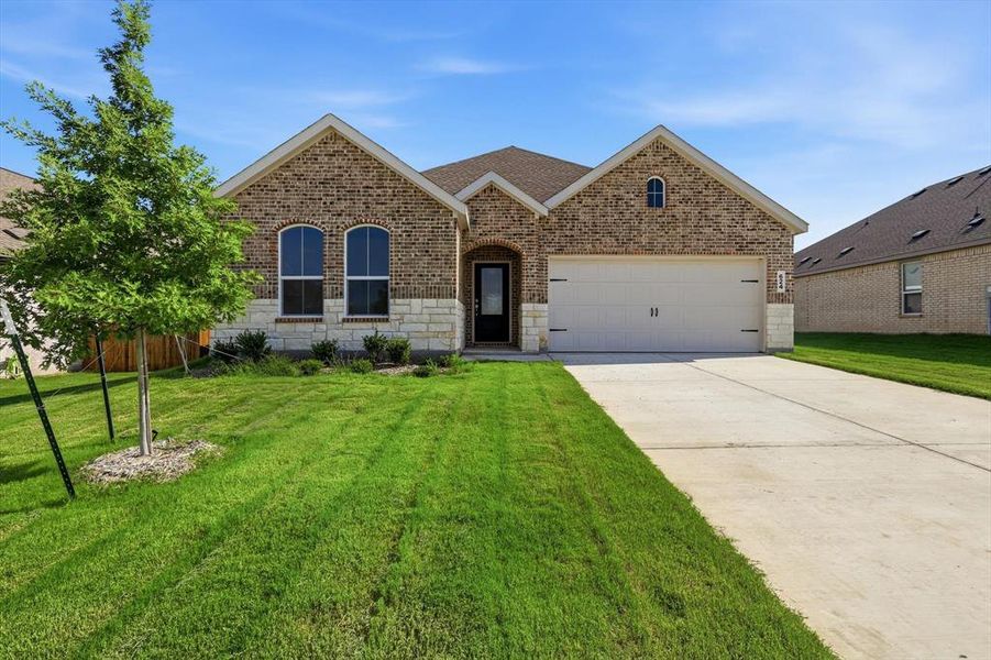 Brick facade with stone accents and a two-car garage Brick facade with stone accents and a two-car garage