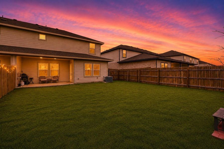Expansive green lawn with a covered concrete patio Expansive green lawn with a covered concrete patio