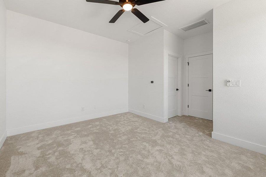 Empty room with light carpet and ceiling fan