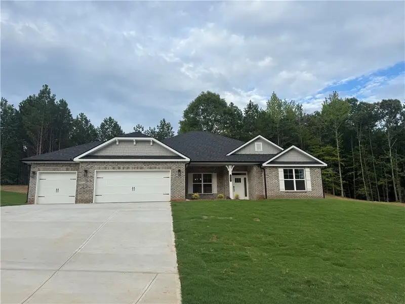 Front exterior of a new home in The Fields of Walnut Creek, Pendergrass, GA, highlighting curb appeal (Image 15). Front exterior of a new home in The Fields of Walnut Creek, Pendergrass, GA, highlighting curb appeal (Image 15).