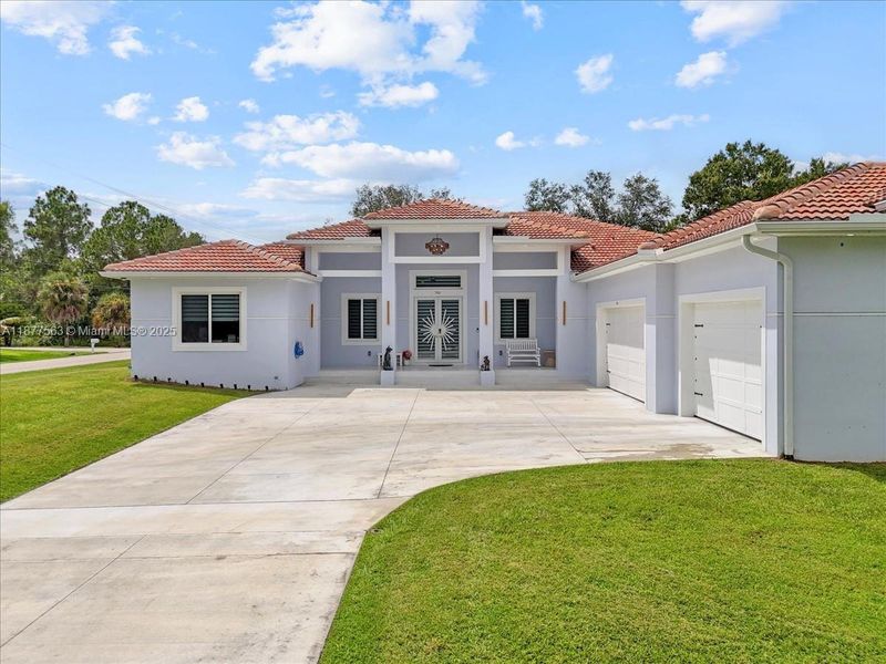 Front exterior of a new home in , Lehigh Acres, FL, highlighting curb appeal (Image 1).