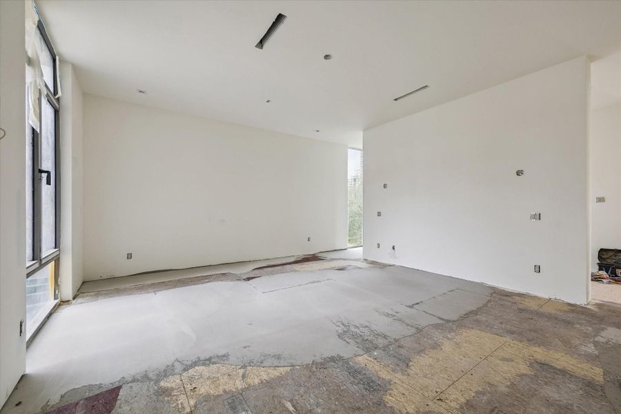 One of the two primary bedrooms featuring a privacy partitioned wall for a sitting room, owner's retreat or baby's nursery
