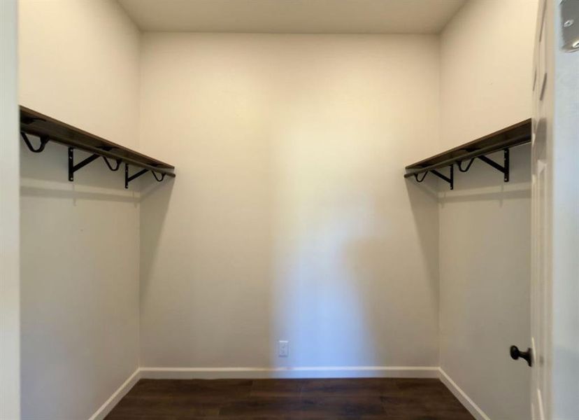 Walk in closet with dark wood-type flooring Walk in closet with dark wood-type flooring