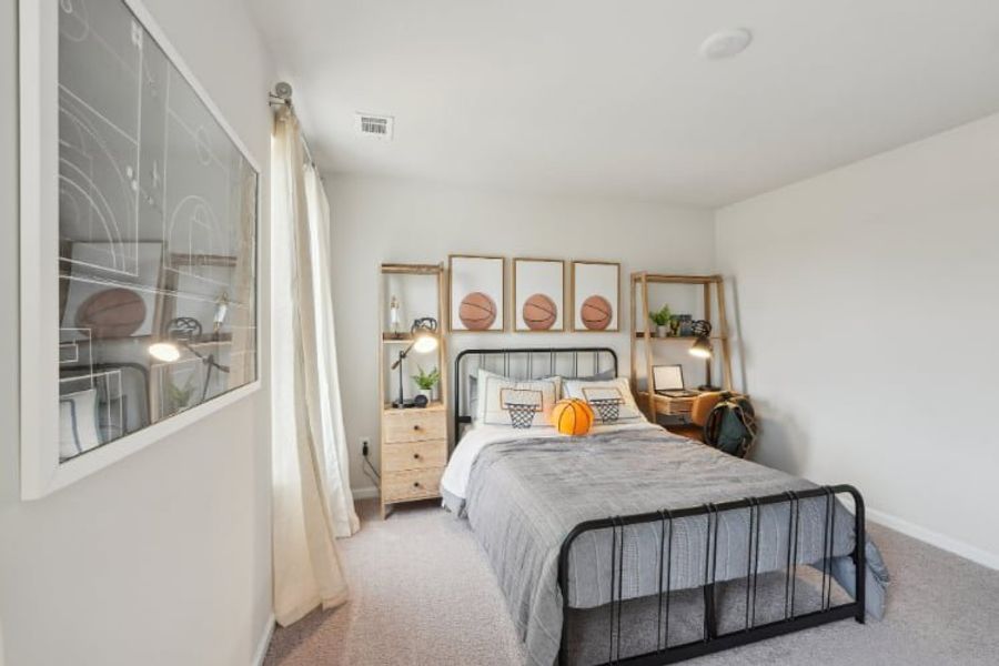 A bedroom with a bed and a window.