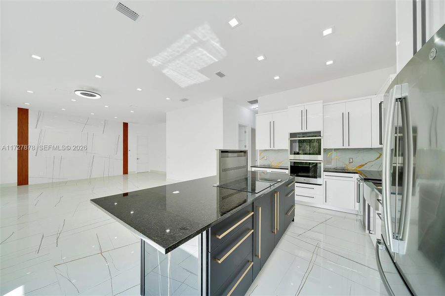 112"X46" GRANITE ISLAND WITH GOLD HANDLES WITH INDUCTION COOKTOP AND DOWNDRAFT HOOD VENTILATOR 112"X46" GRANITE ISLAND WITH GOLD HANDLES WITH INDUCTION COOKTOP AND DOWNDRAFT HOOD VENTILATOR