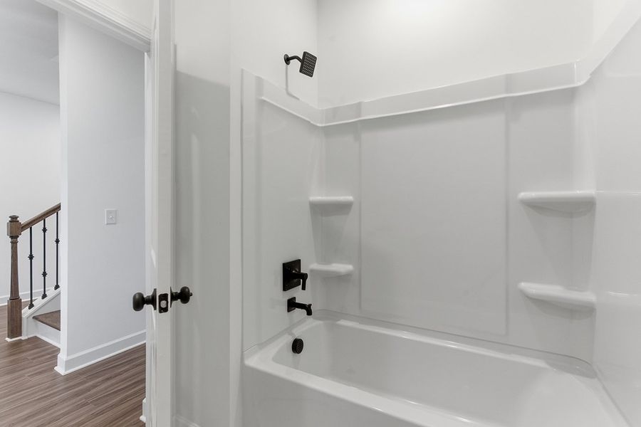 A bathroom with a bathtub and sink.