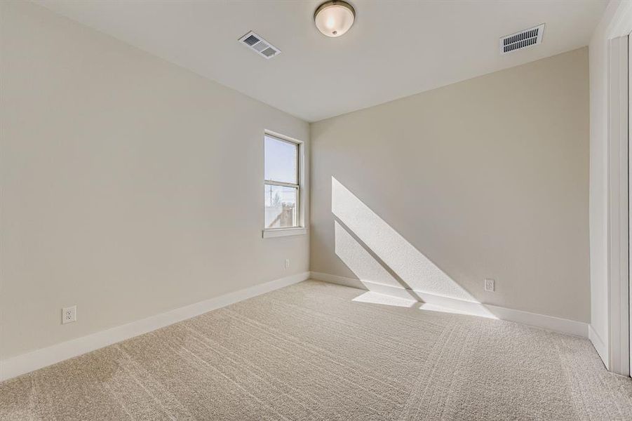Carpeted empty room with baseboards