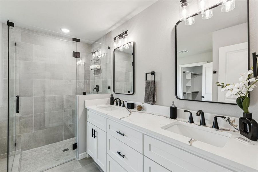 Bathroom with double vanity and a shower stall