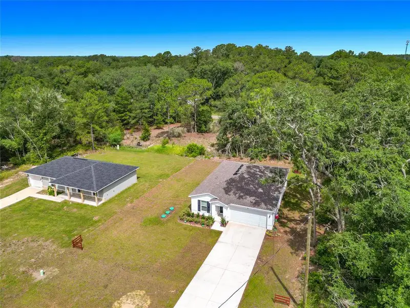 Front exterior of a new home in The Collection at Ocklawaha, Ocklawaha, FL, highlighting curb appeal (Image 27). Front exterior of a new home in The Collection at Ocklawaha, Ocklawaha, FL, highlighting curb appeal (Image 27).