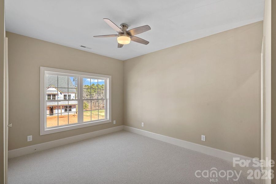 One of the 3 light-filled secondary bedrooms offering flexibility for guests or family.