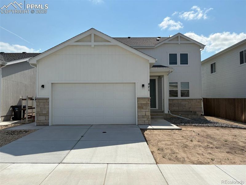 Front exterior of a new home in , Calhan, CO, highlighting curb appeal (Image 1).