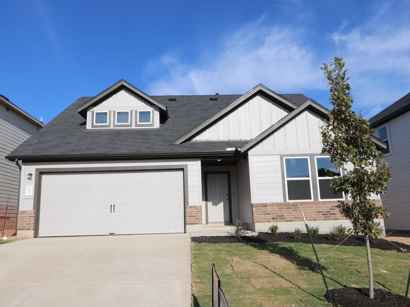 Front exterior of a new home in Cascades at Onion Creek, Austin, TX, highlighting curb appeal (Image 14).