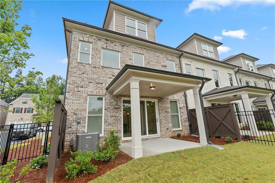 Front exterior of a new home in Waterside Townhomes, Peachtree Corners, GA, highlighting curb appeal (Image 14).