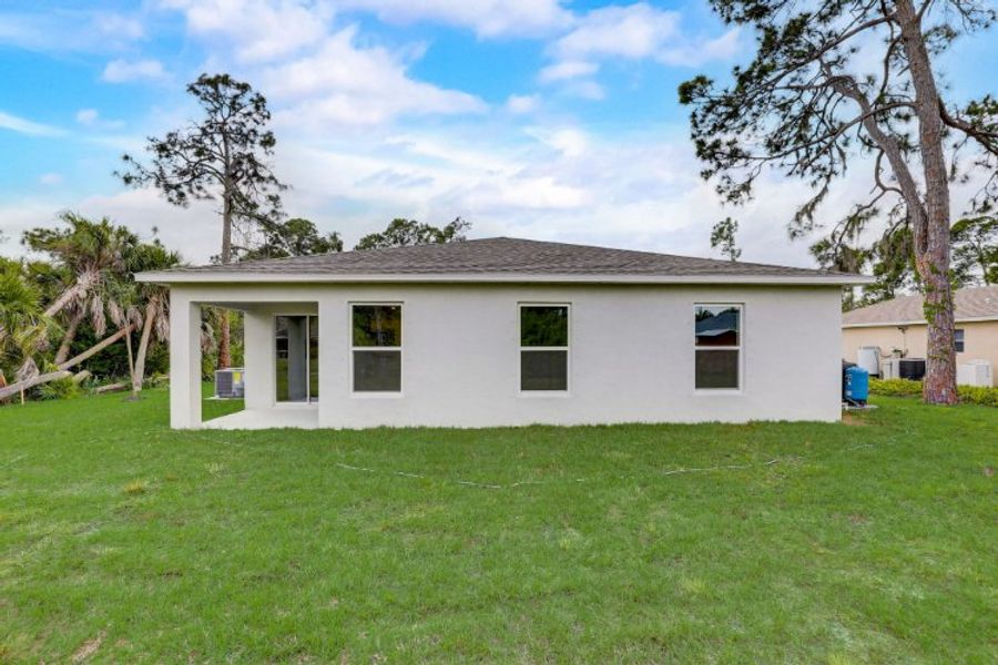 A white house with a grass yard. A white house with a grass yard.