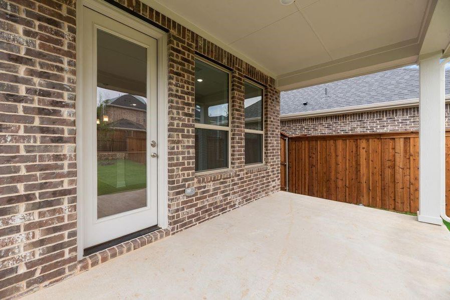 Exterior details and patio area of a home in Spiritas Ranch, Little Elm (Image 25).