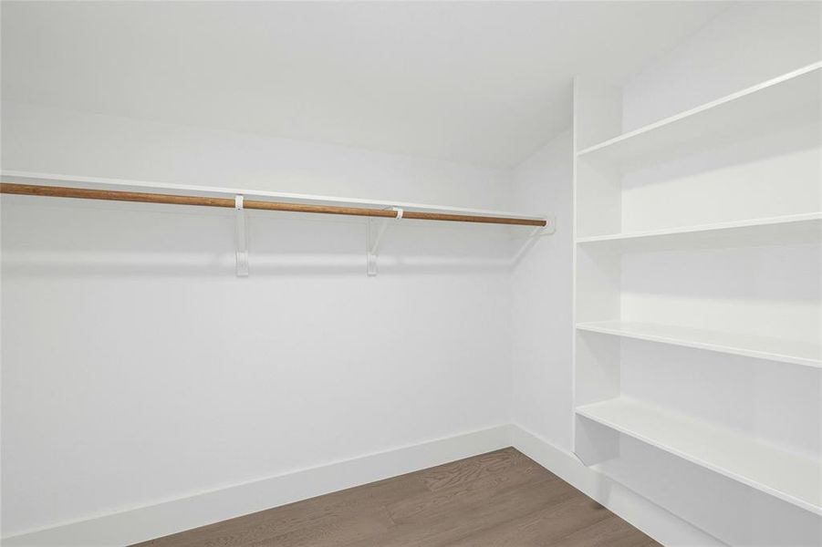 Spacious closet with wood finished floors