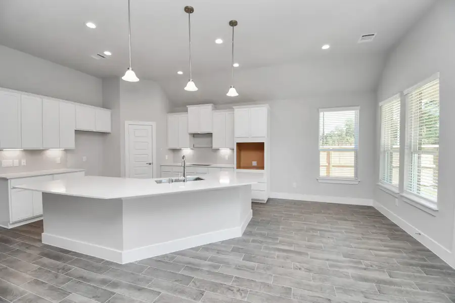 The extended counter area adds both practicality and style, making meal preparation a breeze. Every detail is thoughtfully designed to enhance the kitchen's functionality and aesthetic appeal. Sample photo of completed home with similar floor plan. Actual colors and selections may vary. The extended counter area adds both practicality and style, making meal preparation a breeze. Every detail is thoughtfully designed to enhance the kitchen's functionality and aesthetic appeal. Sample photo of completed home with similar floor plan. Actual colors and selections may vary.