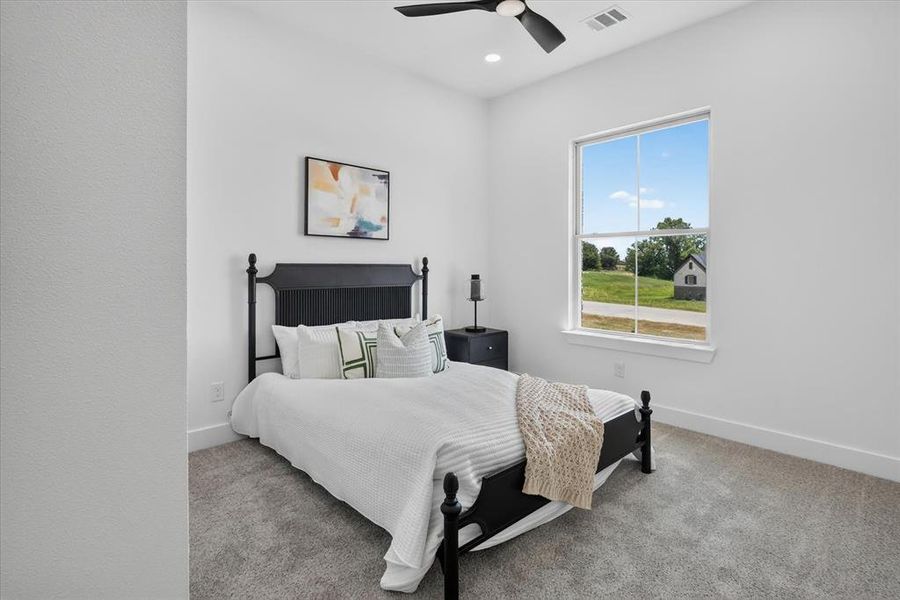 Bright room with a large window, recessed lighting, and a ceiling fan