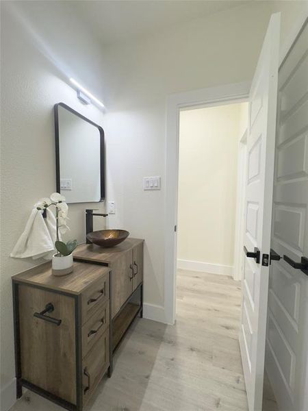 Bathroom featuring wood-type flooring and vanity