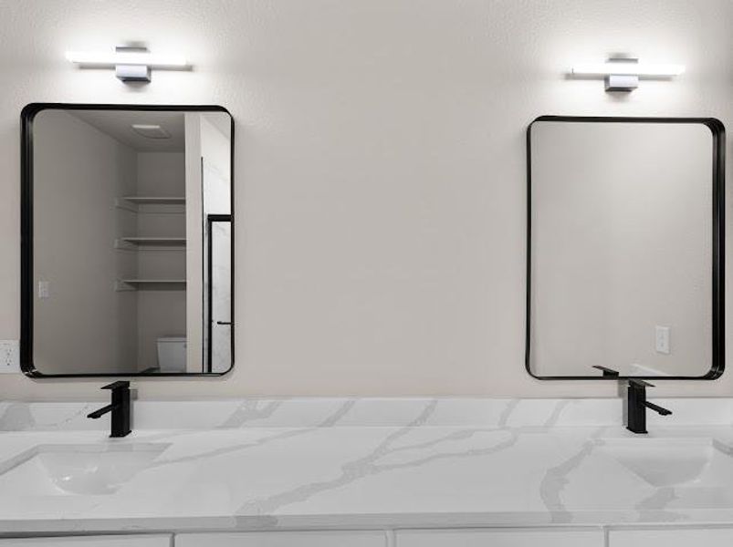 Bathroom view of double vanity and toilet