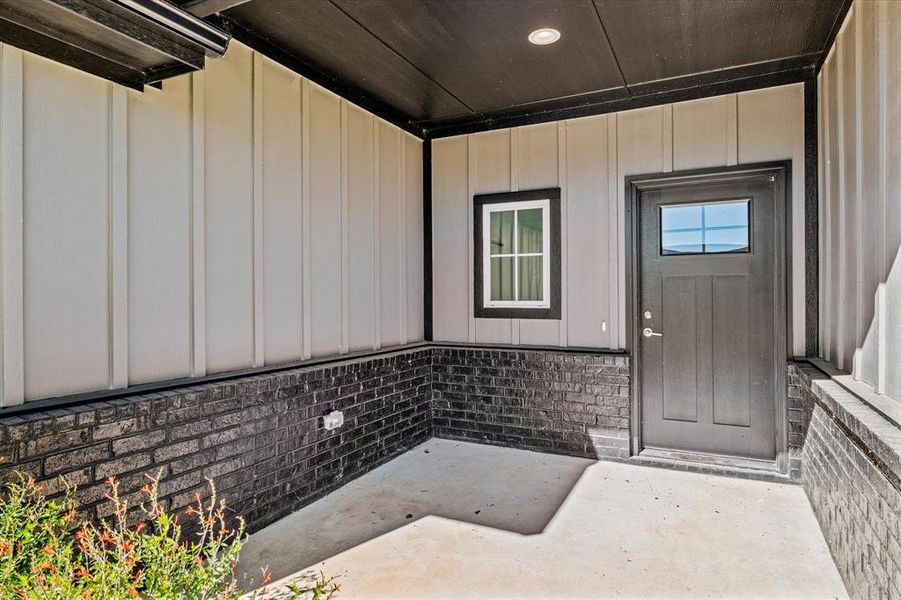 View of exterior entry with a patio