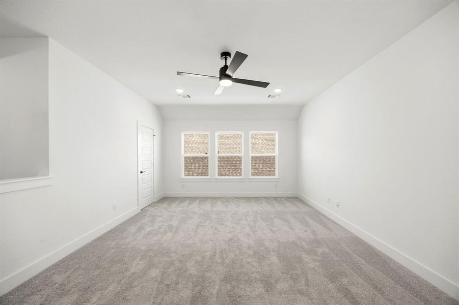 Spare room with light carpet and ceiling fan