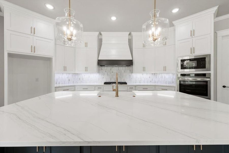 Kitchen island with a quartz countertop and integrated sink