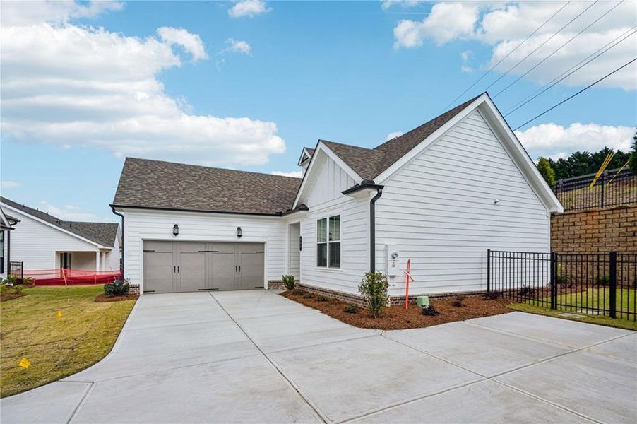 Front exterior of a new home in Promenade at Sawnee Village, Cumming, GA, highlighting curb appeal (Image 17).