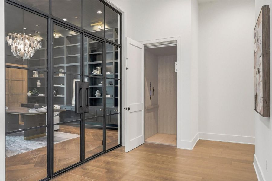 The front entry into your home office is right next the elevator, which services all three floors. Hallway to the south wing of the home includes a powder bath and your first-floor utility room. The front entry into your home office is right next the elevator, which services all three floors. Hallway to the south wing of the home includes a powder bath and your first-floor utility room.