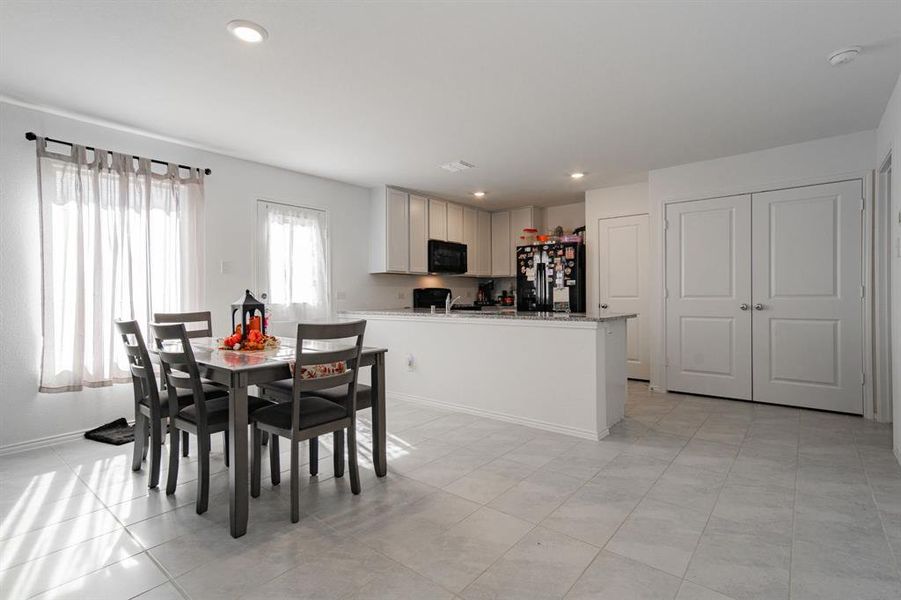 Dining room with recessed lighting and light tile patterned floors