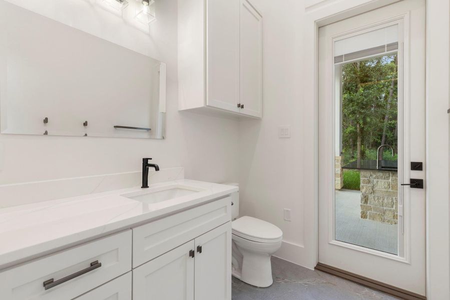 Game room bath leading to outdoor patio.