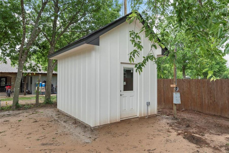View of outdoor structure with fence and an outdoor structure