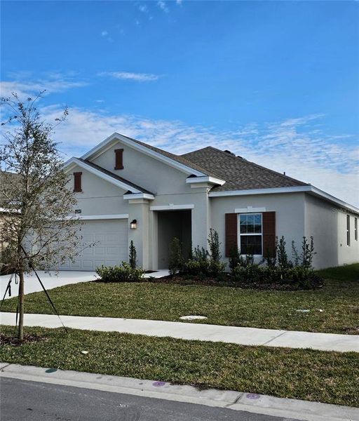 Front exterior of a new home in Storey Creek: Estate Collection, Kissimmee, FL, highlighting curb appeal (Image 2).
