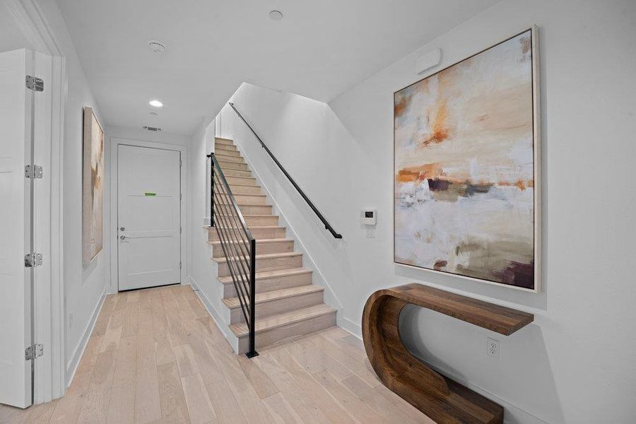 Entryway with light wood-style floors and recessed lighting Entryway with light wood-style floors and recessed lighting