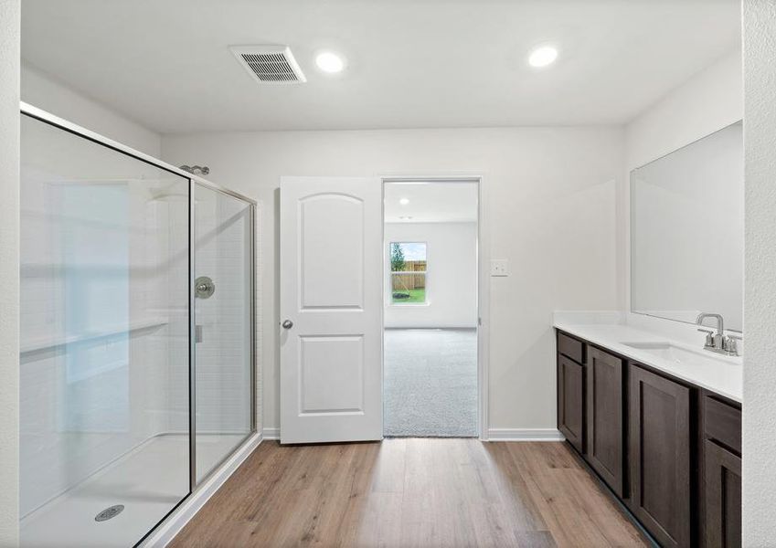 The master bathroom has a glass, walk-in shower.