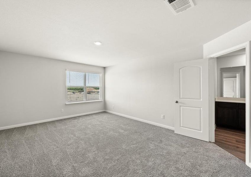 The master bedroom of the Rayburn is spacious and has a large window that lets in great, natural light.