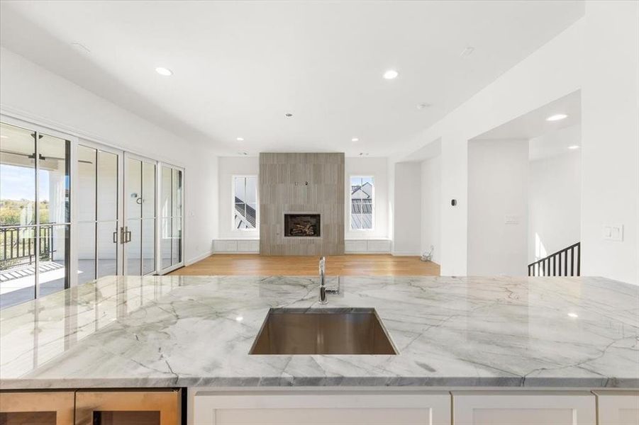 Upstairs game room adjacent to outdoor living also includes full walk in bar with quartzite counters, sink, refrigerator and custom cabinetry; perfect for your Super Bowl gathering.