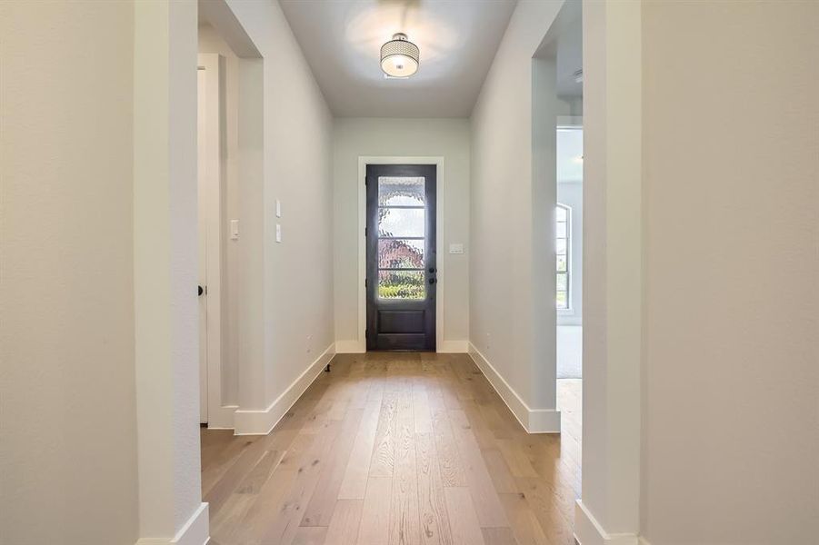 Entrance foyer with light wood-style floors and baseboards Entrance foyer with light wood-style floors and baseboards