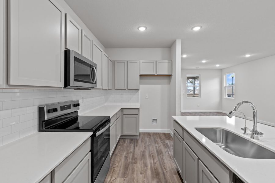 A kitchen with white cabinets. A kitchen with white cabinets.