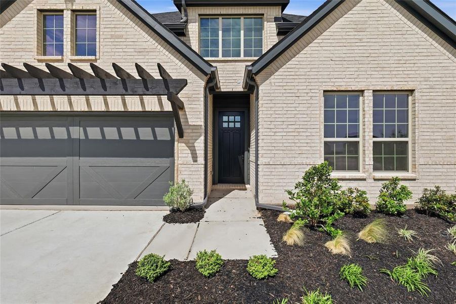 View of front facade featuring driveway and brick siding View of front facade featuring driveway and brick siding