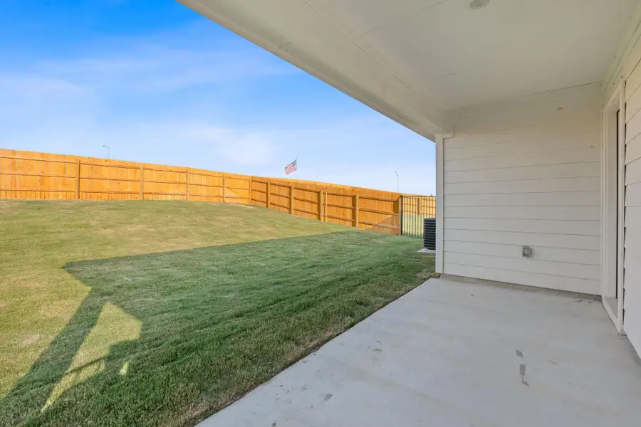 Fenced backyard featuring a patio