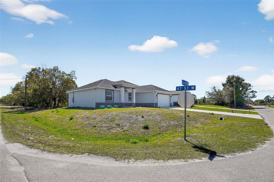 Front exterior of a new home in , Lehigh Acres, FL, highlighting curb appeal (Image 16). Front exterior of a new home in , Lehigh Acres, FL, highlighting curb appeal (Image 16).