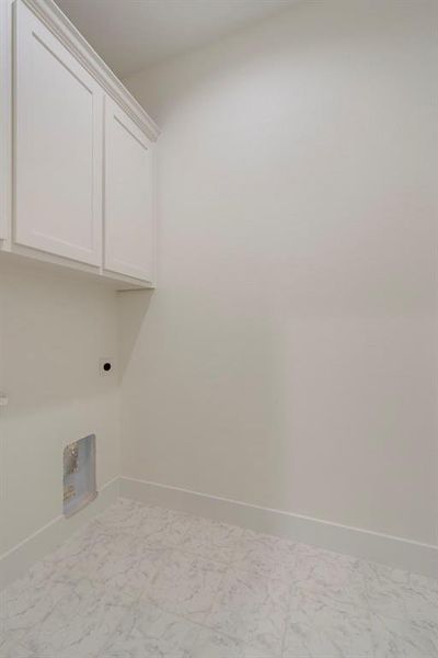 Laundry room with cabinets and hookup for an electric dryer