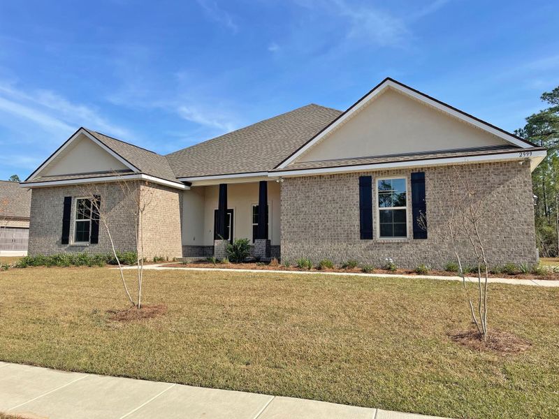 Front exterior of a new home in Iron Rock, Cantonment, FL, highlighting curb appeal (Image 2).