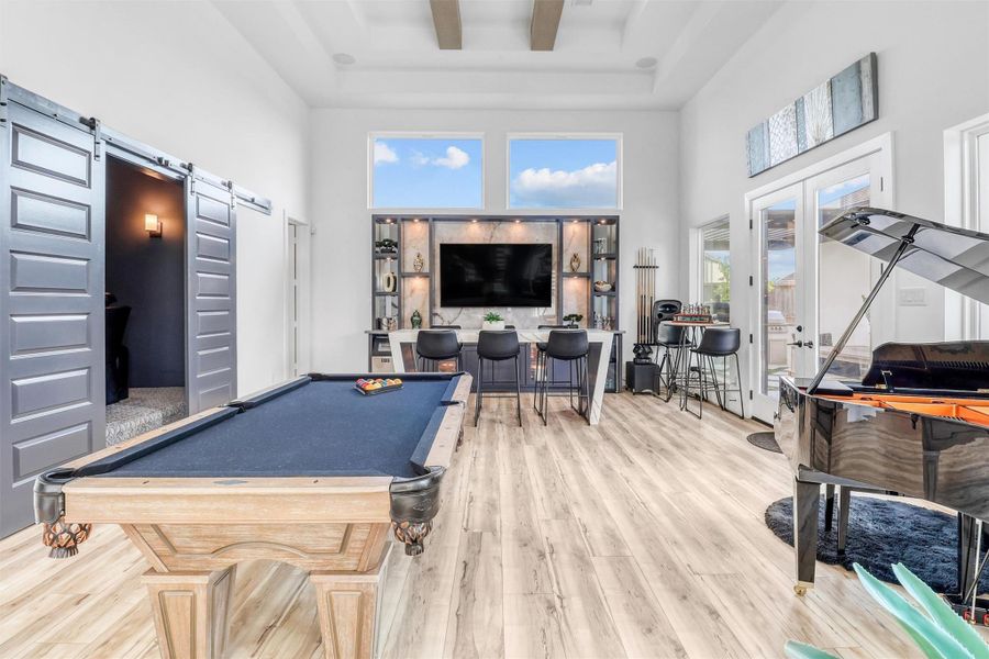 This is where the entertainers entertain! This game room is wired for sound, and features a built-in bar with recessed lighting, drink fridge, TV hook-up, and plenty of room for a pool table, foosball table, arcade games, whatever your heart desires!