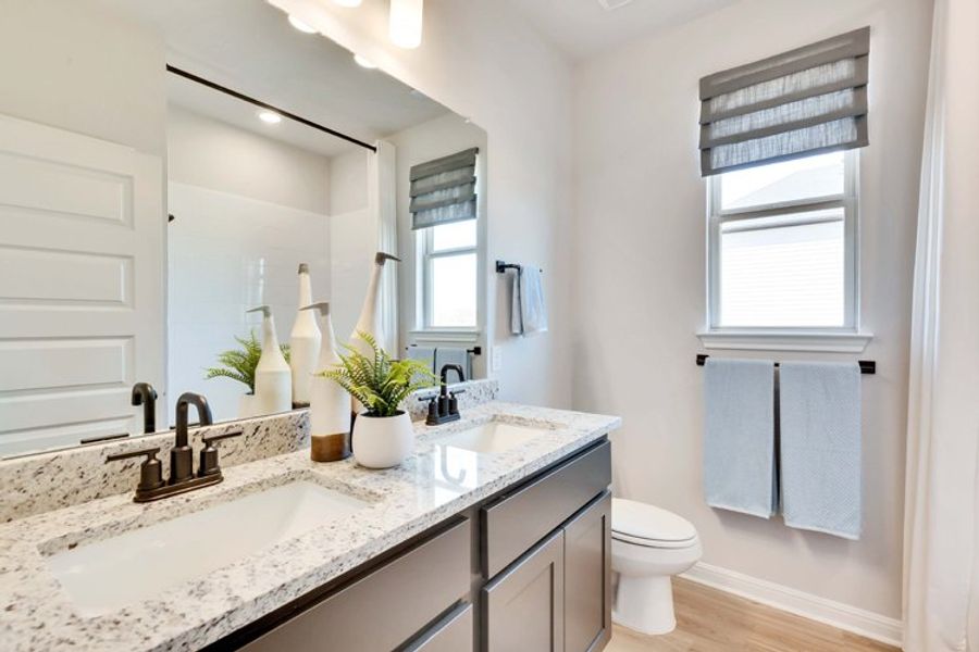 A bathroom with a sink toilet and towels. A bathroom with a sink toilet and towels.