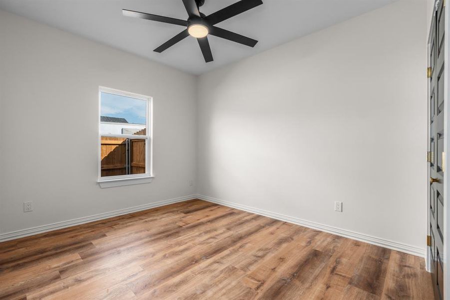 Empty room featuring light wood-style flooring and ceiling fan Empty room featuring light wood-style flooring and ceiling fan