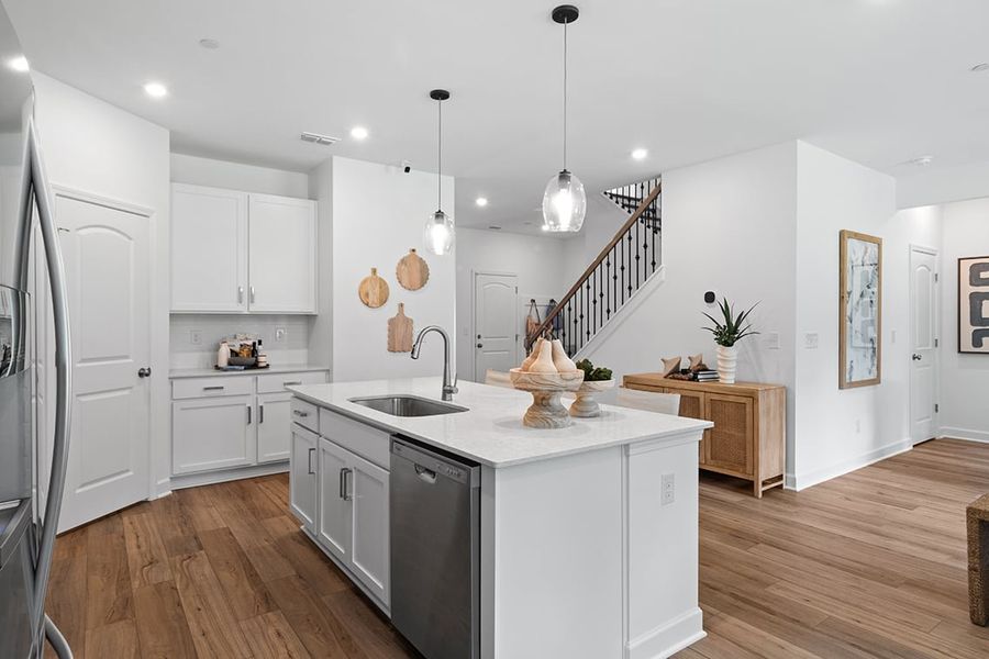 A kitchen with white cabinets.
