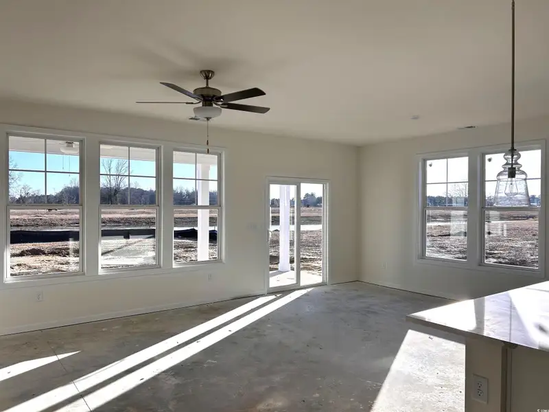 Spare room with concrete flooring and a ceiling fan
